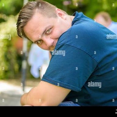A person with a shy, slightly teasing smile.
