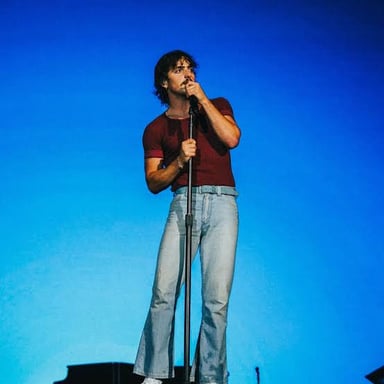 Singer Benson Boone performing on stage.