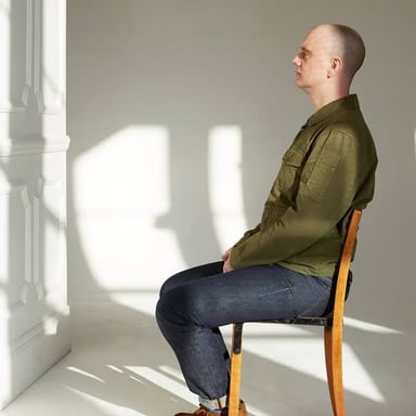 A person sitting quietly without an apparent task.