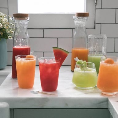 A glass of water beside a fruit-flavored agua fresca.