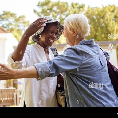 Two people embracing in a warm greeting.