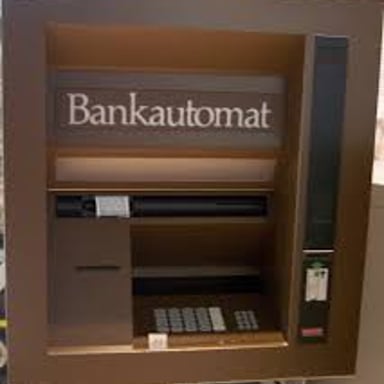 An automated teller machine set into a bank wall.