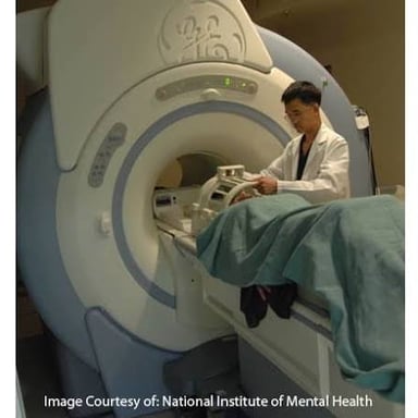 A patient undergoing an MRI scan in a cylindrical scanner