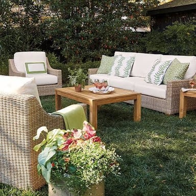 A table and chairs arranged as outdoor patio furniture.