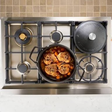 A heavy cast-iron pot with a close-fitting lid
