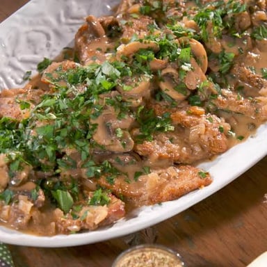 A plate of veal Marsala with mushroom sauce