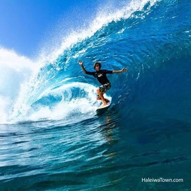 A surfer riding a curling wave at the Banzai Pipeline on Oahu’s North Shore.