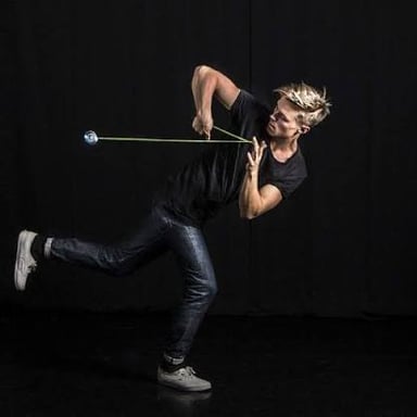 A yo-yo swinging in a wide circular path around its player's body.