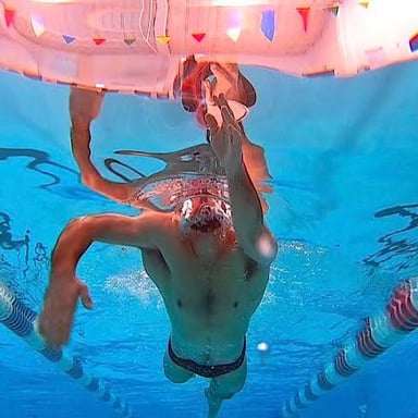 A swimmer doing the front crawl in a pool, illustrating the clue’s alternate meaning of “crawl.”