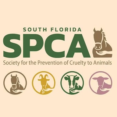 An animal-welfare organization sign beside pets awaiting care or adoption.