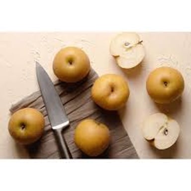 Whole Asian pears beside a sliced pear showing its pale, crisp flesh.