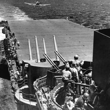 A naval aircraft landing on an aircraft carrier’s flight deck.