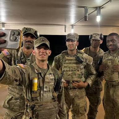 A sergeant giving guidance to soldiers on a military base.