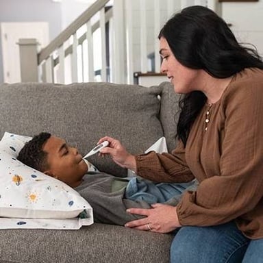 An adult caring for a child, illustrating the sense of rear as bring up.
