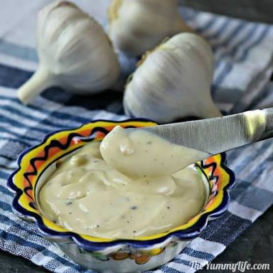 A bowl of creamy aioli, a garlic sauce often served as a dip or spread.
