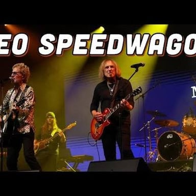 Members of the American rock band REO Speedwagon performing together.