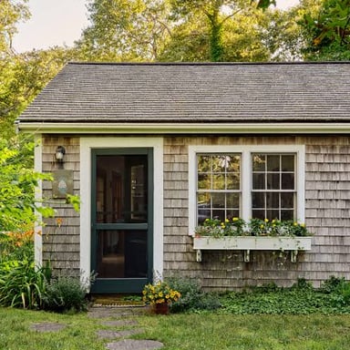 A small, modest house in a rural setting.