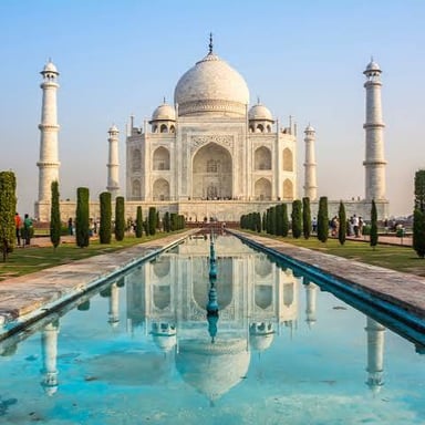 The white-marble Taj Mahal viewed across its reflecting pool and formal gardens in Agra.