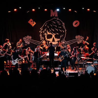 A rock band performing live, representing emo music.
