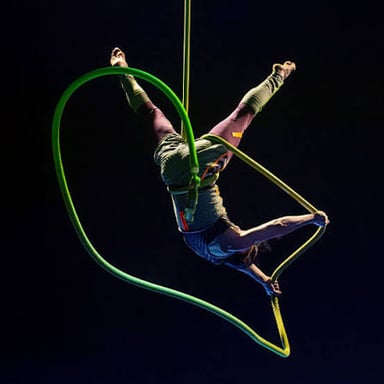 An aerial acrobat performing a stunt above the ground