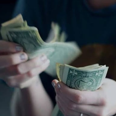 A person handing money back to another person