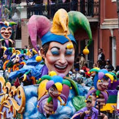 Colorful floats moving through a New Orleans Mardi Gras parade.