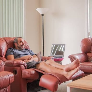 A person reclining on a sofa.