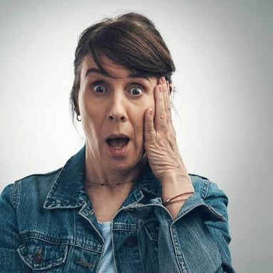 A person showing surprise at unexpected news
