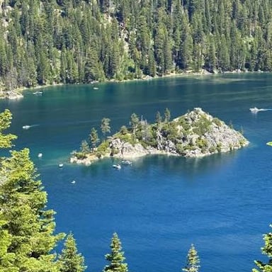 Lake Tahoe’s clear blue water beneath the surrounding Sierra Nevada mountains.