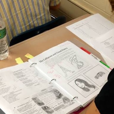 Student consulting notes during an exam.