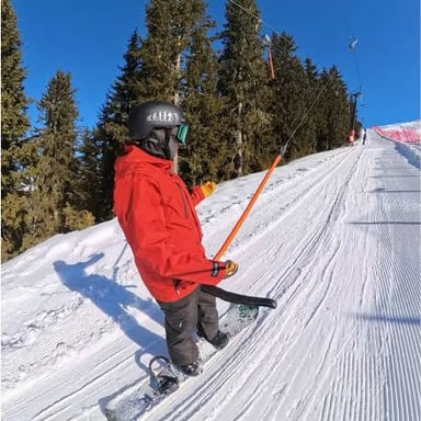 Skiers being pulled uphill by a T-bar surface lift.
