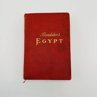 A vintage Baedeker travel guidebook, recognizable by its red cover.