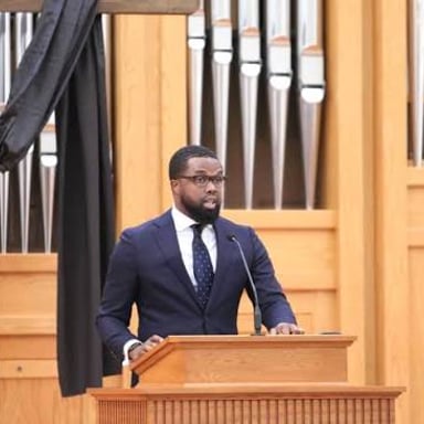 A pastor speaking to a congregation during a church service.