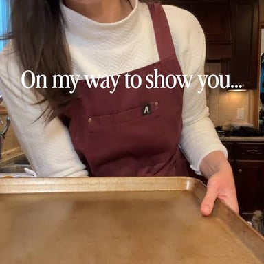 A person standing thoughtfully near food being prepared