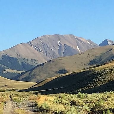 A pointed mountain summit rising above the surrounding landscape.