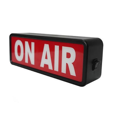 An illuminated ON AIR sign in a broadcast studio.