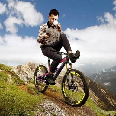 A cyclist rolling downhill without pedaling, illustrating the sense of coasting.