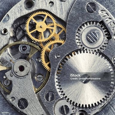 A toothed gear inside a clock mechanism.