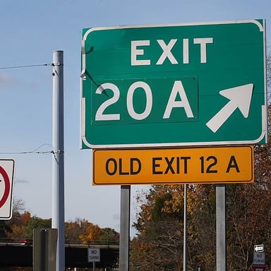 A green highway sign marking an exit.