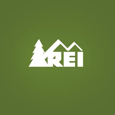 An REI outdoor retail store displaying the company's green logo.