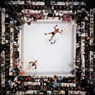 Muhammad Ali boxing in a ring.