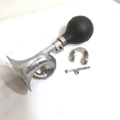 A hand squeezing a bicycle horn.