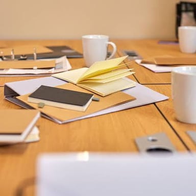 Loose papers and notes spread across a desk.