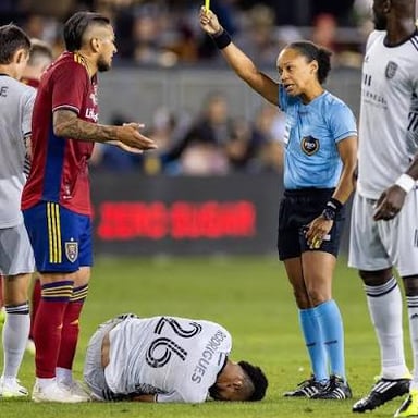 A soccer referee officiating a National Women’s Soccer League match.