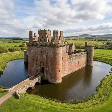 A medieval castle with a moat around its walls.