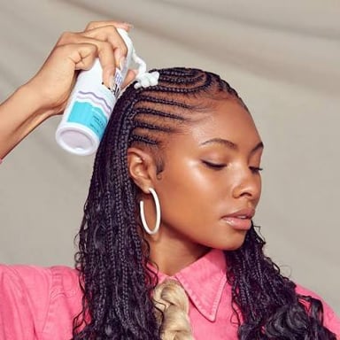 Styling mousse being worked through damp hair.