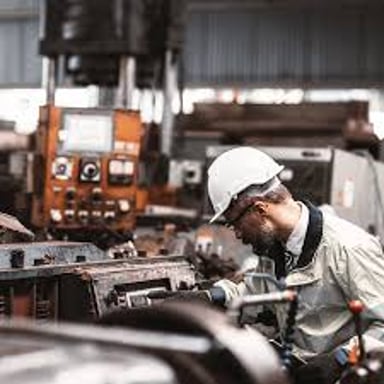 Technicians work on machinery during a refit.