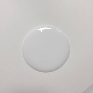 A small gooey lump of adhesive on a surface