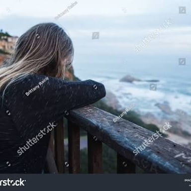 A person gazing toward a distant place, suggesting longing.