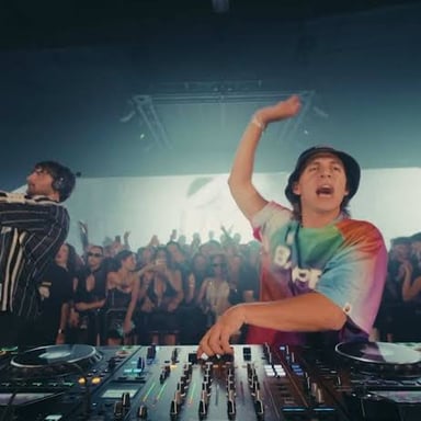 A DJ working a mixer in a dance club.